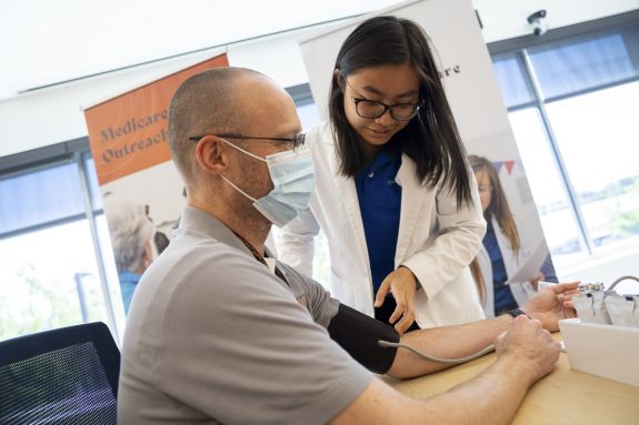 PharmD student taking a patient's blood pressure