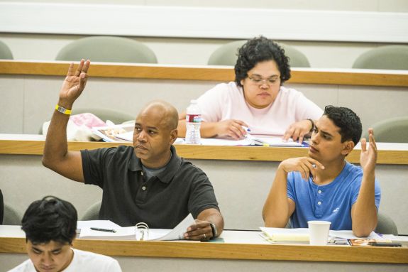 Two students raise their hands during class