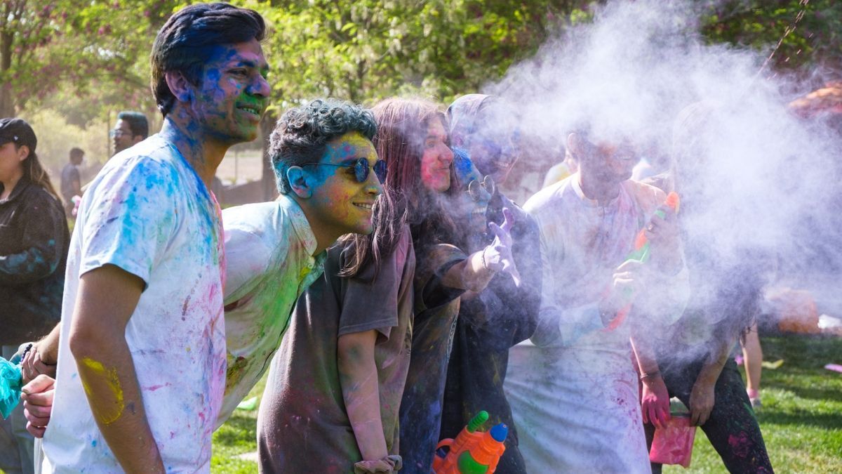 students pose for a photo at a holi event