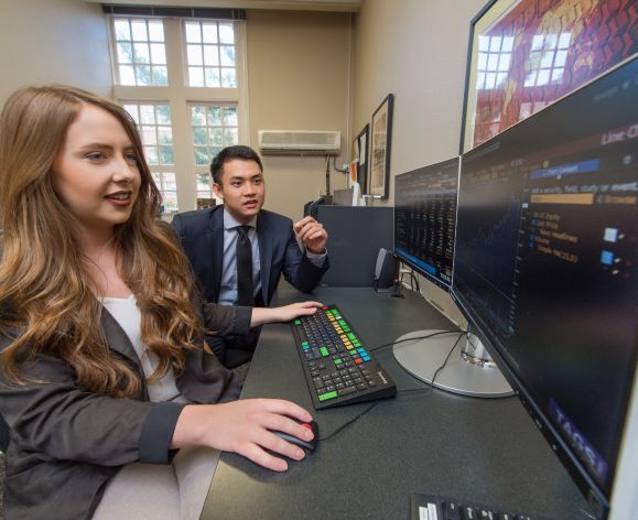 Students managing funds with computers